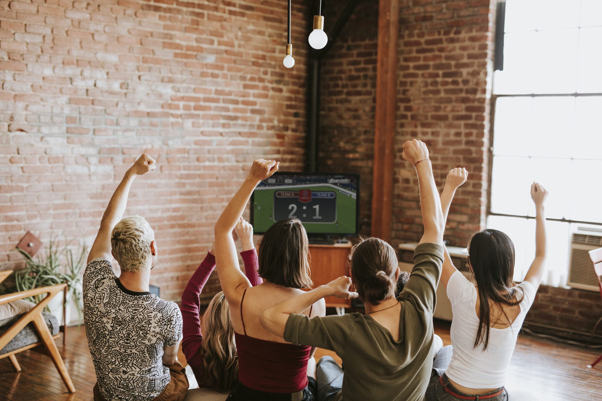 Friends watching a game show on the tv